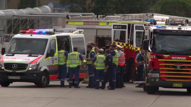 Emergency services at the scene after two people died in a shipping container accident in Wetherill Park.