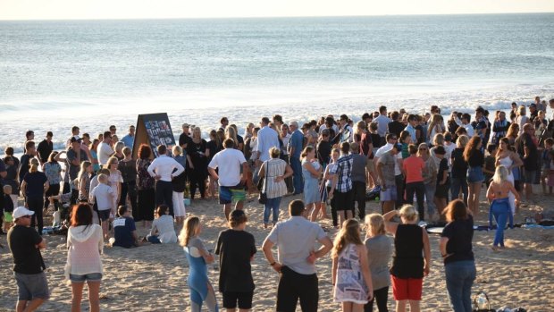 Friends and family of Laeticia Brouwer gather for a tribute paddle-out at Singleton beach.
