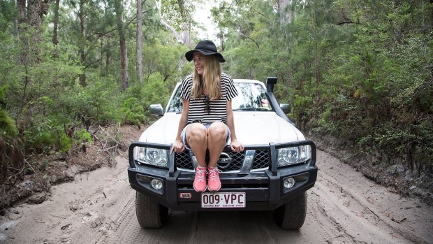 Queen of the road: Triumphant after negotiating an inland sand track on Fraser Island. Photo: Kristen Appelstun