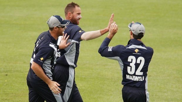 Victoria's John Hastings celebrates with teammates after claiming a wicket.