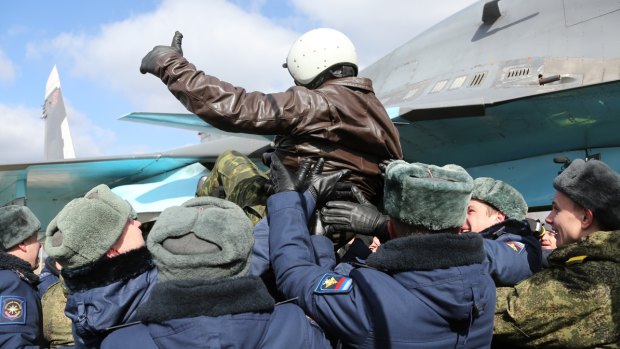 A Russian pilot receives a hero's welcome on returning from Syria at an airbase near the Russian city Voronezh on Tuesday.