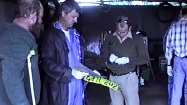 Francis Wark accompanying police during a search of his home in August 1999. 
