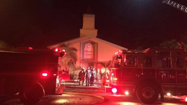 Firefighters work at the scene of a fire at the Islamic Centre of Fort Pierce on Monday.