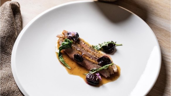 Dry-aged Macedon Ranges duck with grapes and greens.