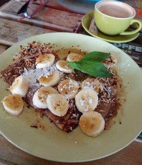 The Kool Korner Crepes ($15), served with roasted coconut flakes and maple syrup.