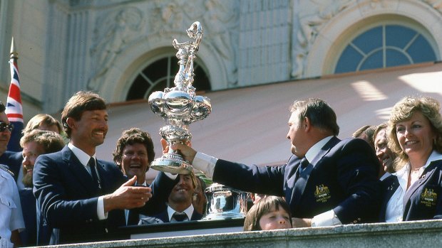 Alan Bond and John Bertram hoist the cup. Lesleigh Green, right.
