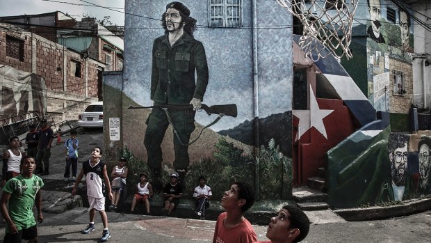 Children of the La Piedrita commune playing basketball on the streets in the Barrio 23 de Enero in Caracas.