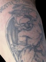 A demon tattoo on Andy's left shoulder.