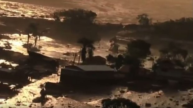 Television images showed a torrent of thick red mud several hundred metres long that had swamped houses as it surged down valleys in the hilly region.