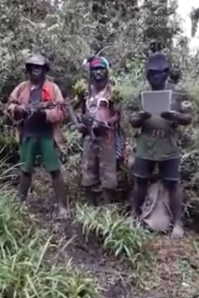 Self-styled West Papuan freedom fighters read out a statement in the jungle.