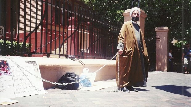 Early cause: Man Monis chained himself to the fence outside NSW Parliament House in 2001.