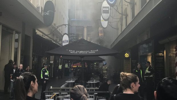 Smoke fills Degraves Street in the city after the cafe fire.