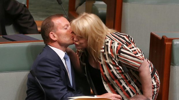 Former prime minister Tony Abbott is greeted by colleague Natasha Griggs as they take their seats on the backbench for question time last month.