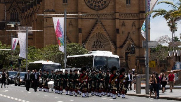 The Scots College pipes and drums band leads the funeral procession outside St Mary's Cathedral.