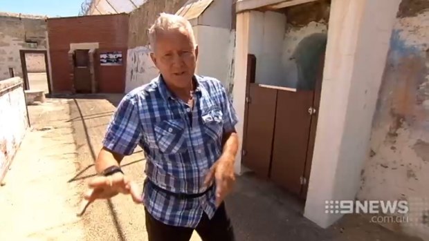 Ray Mickelberg at Fremantle Prison, describing the area where his finger was bitten off completely.