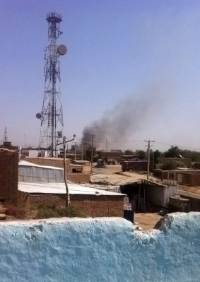 Smoke rises from a police station during clashes between Taliban fighters and Afghan security forces in Kunduz city.