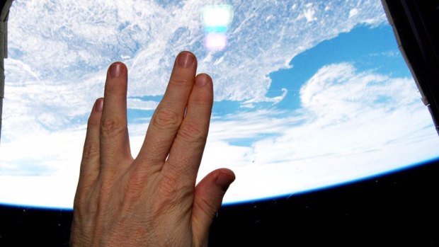 Astronaut Terry Virts gives the Vulcan salute from the cupola of the International Space Station in a tribute to actor Leonard Nimoy.