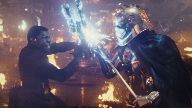 Star Wars: The Last Jedi. L to R: Finn (John Boyega) battling Captain Phasma (Gwendoline Christie). 