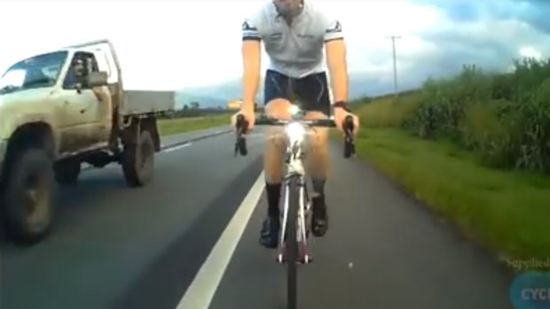 A cyclist captured on camera the moment a bottle is hurled at one of his fellow riders at Cairns.