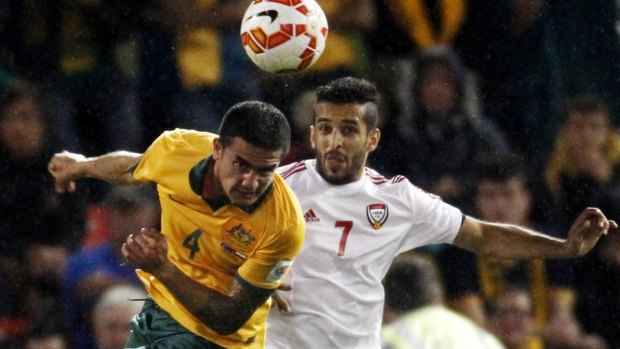 Focused: Tim Cahill wins a header against the UAE.