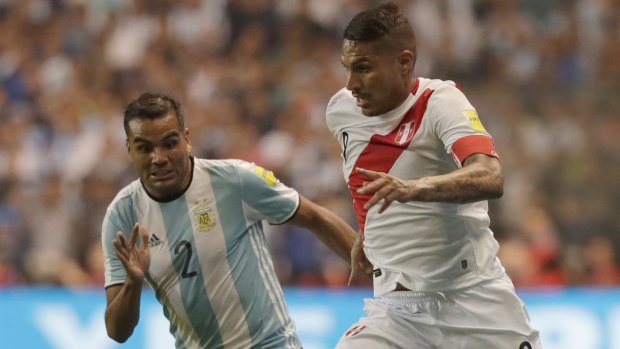 Argentina's Gabriel Mercado, left, contests possession with Peru's Paolo Guerrero.