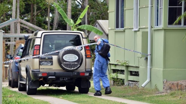 A forensics police officer arrive at the scene of the Gympie home invasion.