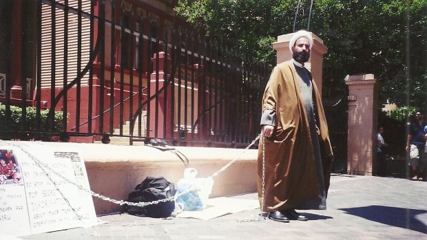 Man Haron Monis chained to the fence at Parliament House in 2001.