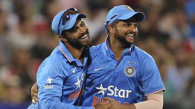India's Ravindra Jadeja, left, and Suresh Raina celebrate the wicket of Matthew Wade.