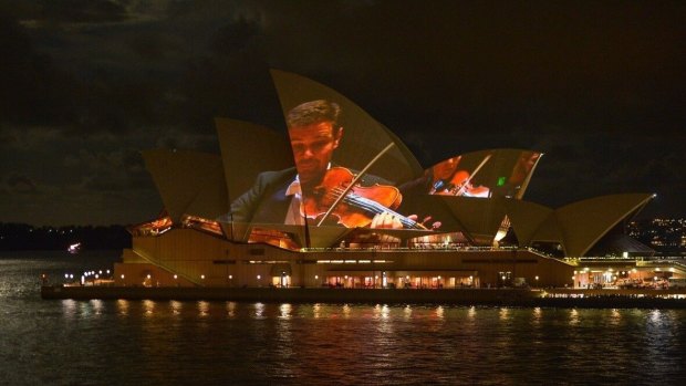 Andrew Haveron fiddling about on sails of the Sydney Opera House.