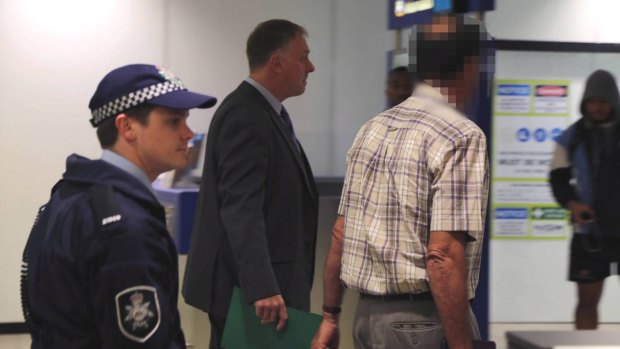 David Standen (right), also known as Peter William Standen, is arrested at Sydney Airport on August 19, 2014.