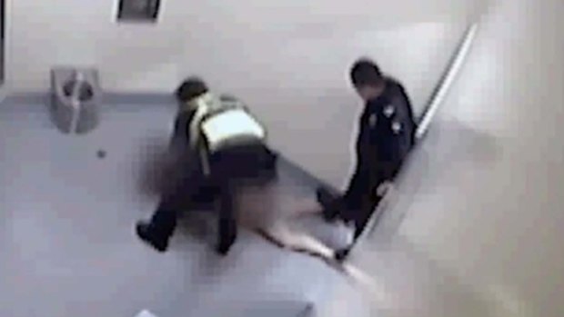 Video still allegedly shows a police officer standing on a woman's legs while she is held in custody in Ballarat