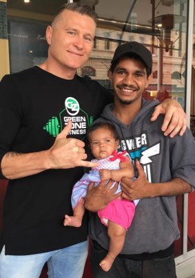 Danny Green with an Indigenous fan and his daughter ahead of Friday's fight.