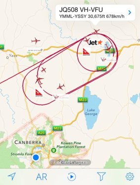 A map showing flights unable to land at Canberra Airport circling around Lake George.