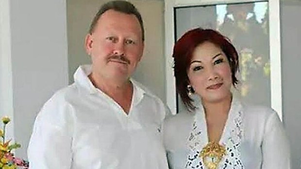 Robert Kelvin Ellis, pictured with his wife Julaikah Noor Aini, was found with his throat slashed.