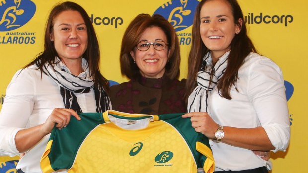 Wallaroos stars Sharni Williams (left) and Shannon Parry (right) with Buildcorp's Josephine Sukkar. 