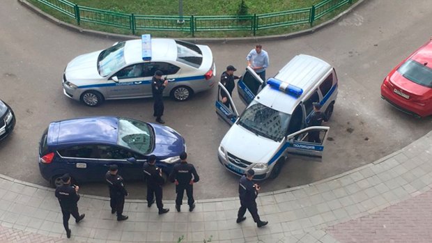 Alexei Navalny, blue shirt, is detained by police outside his apartment in Moscow, Russia.