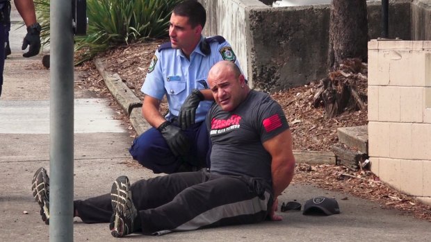 An unidentified man was handcuffed following the fatal shooting at Bankstown Central Shopping Centre, but was later released.