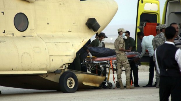 Egyptian emergency workers unload bodies of crash victims near Suez, Egypt.