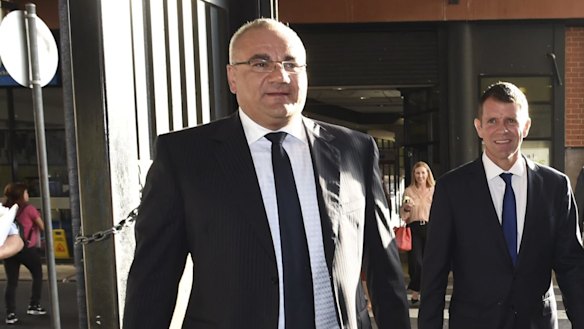 NSW Premier Mike Baird in Auburn during last year's state election campaign with Liberal candidate Ronney Oueik, who spent $150,000 of his own money trying to disrupt Luke Foley's bid for the seat. 