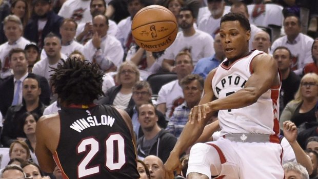 Heading out of bounds: Toronto Raptors guard Kyle Lowry plays the ball off of Miami Heat's Justise Winslow to keep possession.