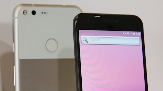 The new Google Pixel phone is displayed next to a Google Home smart speaker.