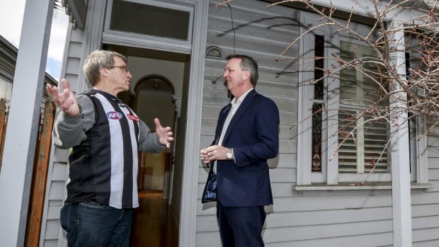 Housing Minister Martin Foley and homelessness program resident Trevor Wulf at a Collingwood house that was acquired for the abandoned East West Link.