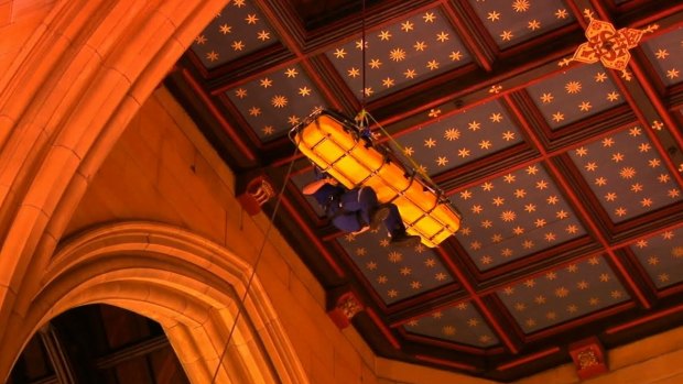 A bell-ringer who had a heart attack is lowered through a trapdoor in the St Mary's Cathedral bell tower.