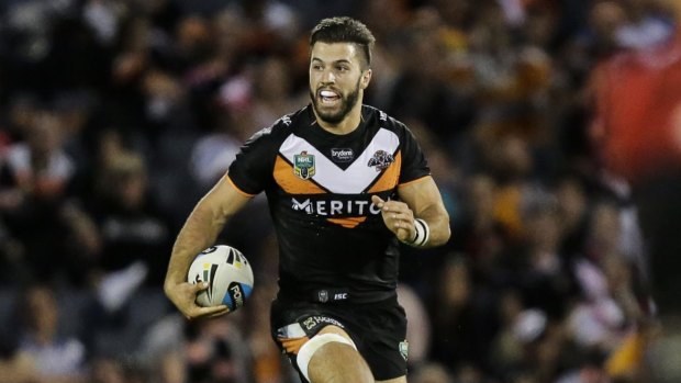 No club name change: James Tedesco of the Wests Tigers makes a break. 