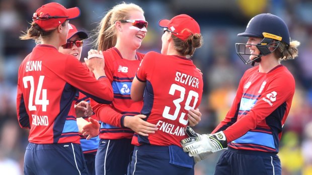Sophie Ecclestone of England (centre) celebrates with teammates after claiming the wicket of Delissa Kimmince.