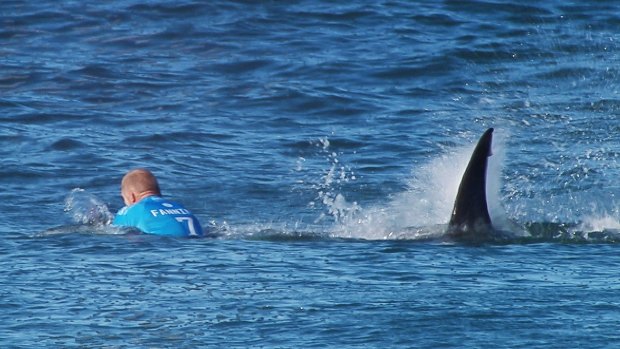 The moment a huge shark launches at Australian surfer Mick Fanning, who escaped without injury after he "punched him in the back". 