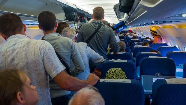 Airlines are creating the crowds by cancelling other flights and packing passengers on the few remaining planes.