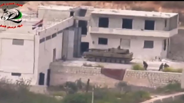 Footage supplied by the Free Syrian Army's Fursan al-Haq Brigade shows a Syrian tank near Ariha, in Syria's Idlib province, moments before a TOW missile strike.
