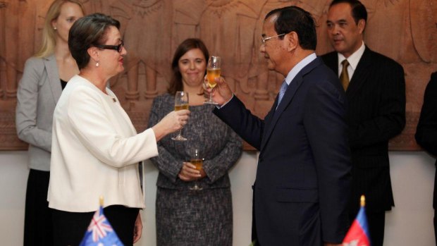 Australia's ambassador in Phnom Penh, Angela Corcoran, toasts the upgrading of ties with Cambodian's Minister of Foreign Affairs Prak Sokhonn.