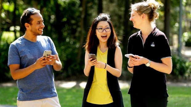 Students Ahmed Alqorashi, Shan Cai and Arlen East at the University of Newcastle, where staff have been warned about using phones while walking.